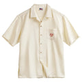 Light apricot men's Cuban collar shirt with bamboo pattern featuring plants and flowers