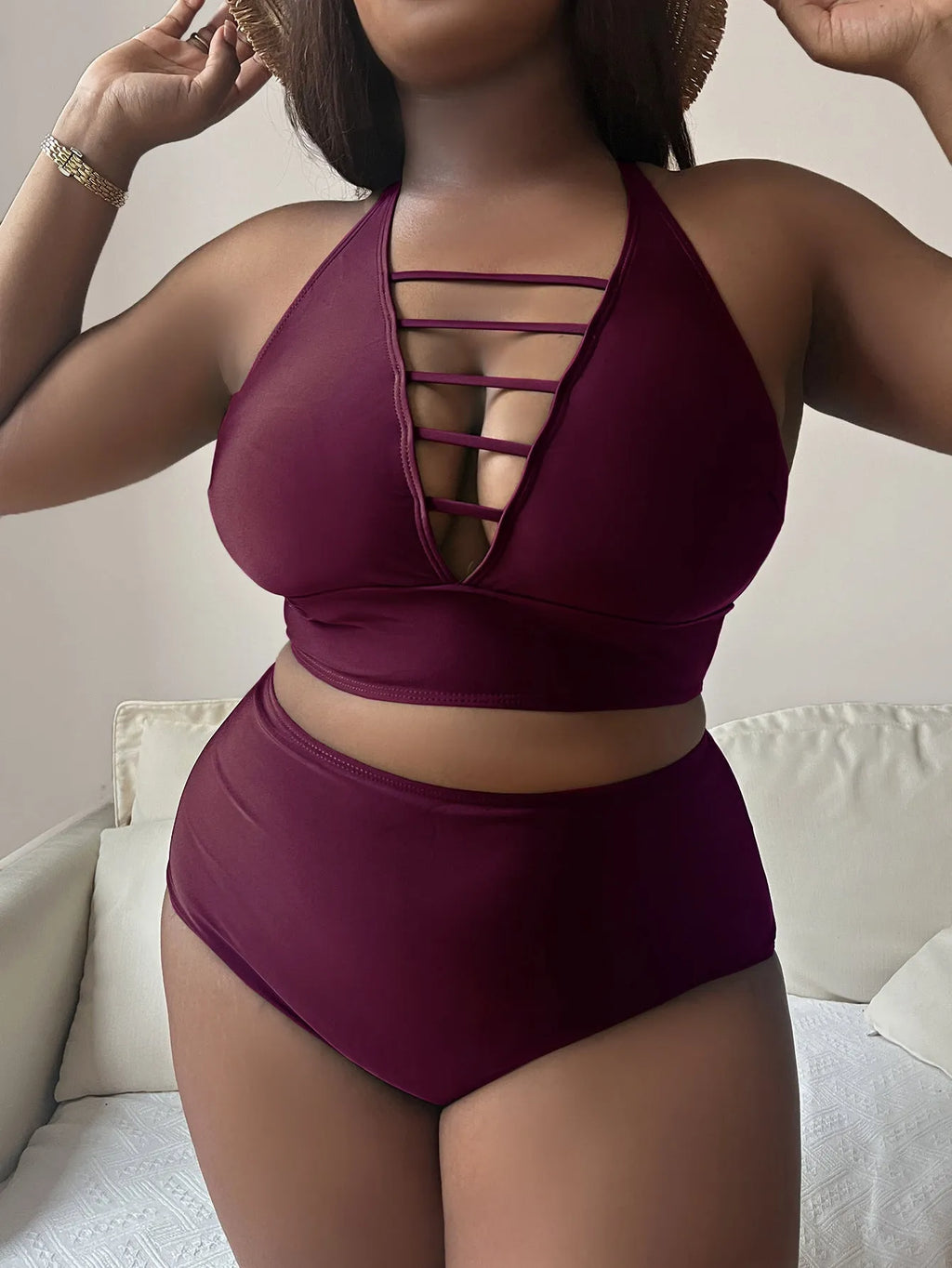 Plus size woman modelling a solid colour halter bikini with adjustable cross straps and high waist briefs.