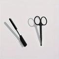 Black dual-head pet grooming brush with soft bristles and a comb, featuring an ambidextrous handle.