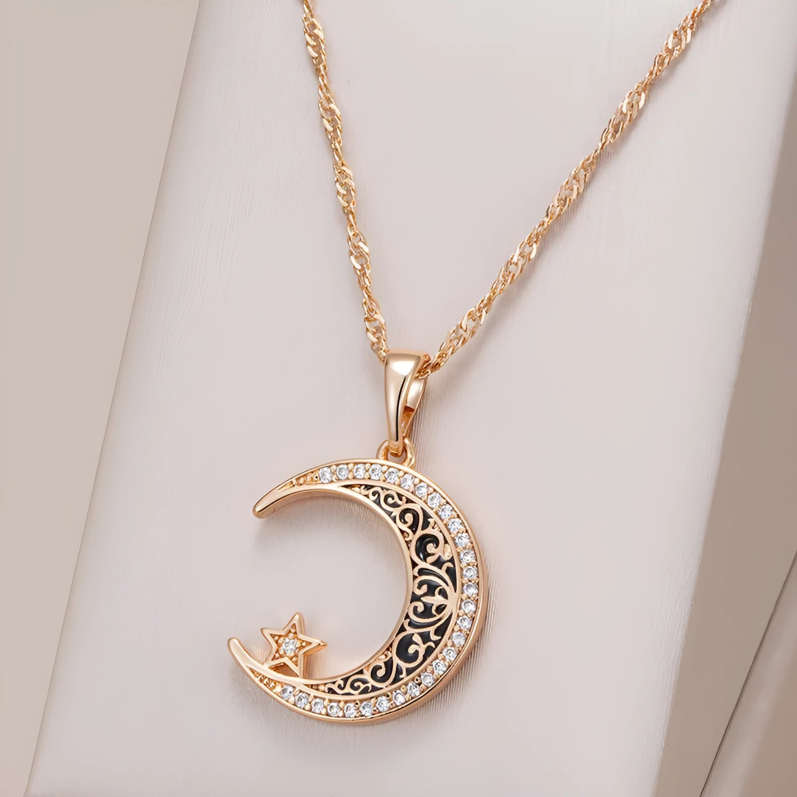 Rose gold necklace with zircon star moon pendant and enamel detailing on adjustable water wave chain