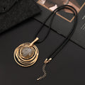 Gold geometric alloy pendant on a brown snakeskin wax rope chain necklace laid flat.
