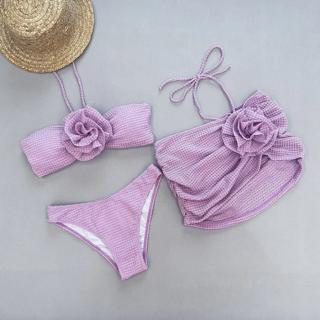 Women's 3D flower split three-piece bikini swimsuit set in purple on a mannequin.