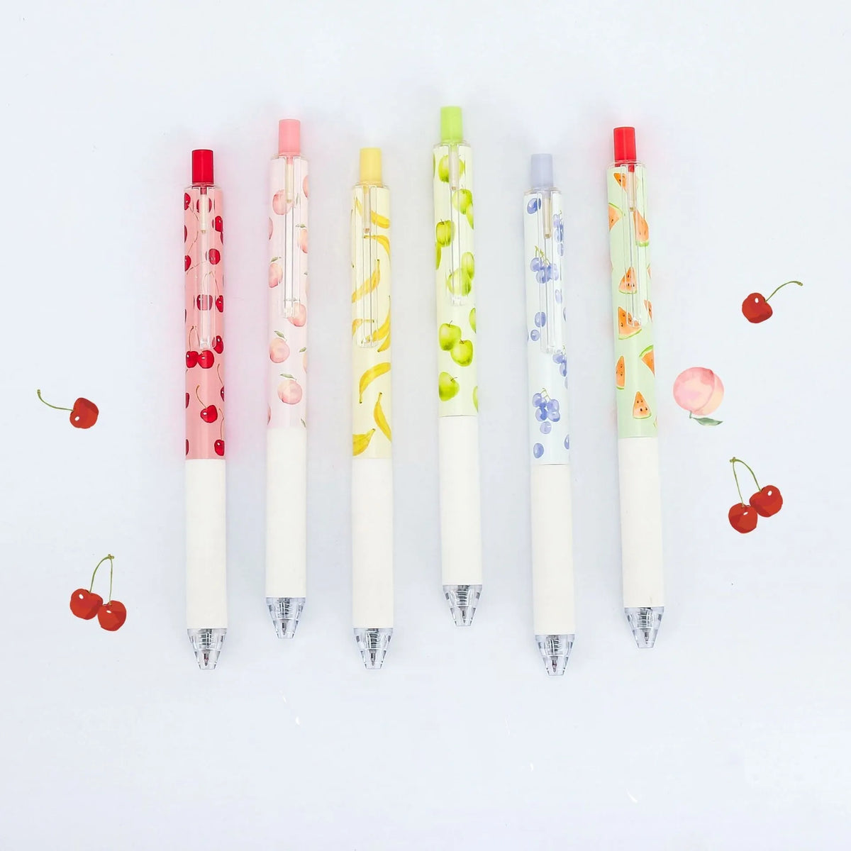 Three fruit-scented press-action pens with plastic barrels and black 0.5mm refills.