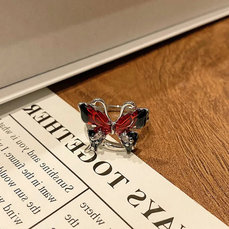 Copper butterfly women's ring with drip oil finish in an open-loop design.