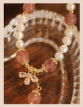 Strawberry quartz crystal bracelet with stringed pearls and bow detail