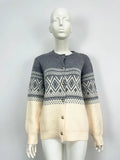 Women's grey alpaca wool cardigan with long sleeves and a diamond knit pattern in contrasting colours.