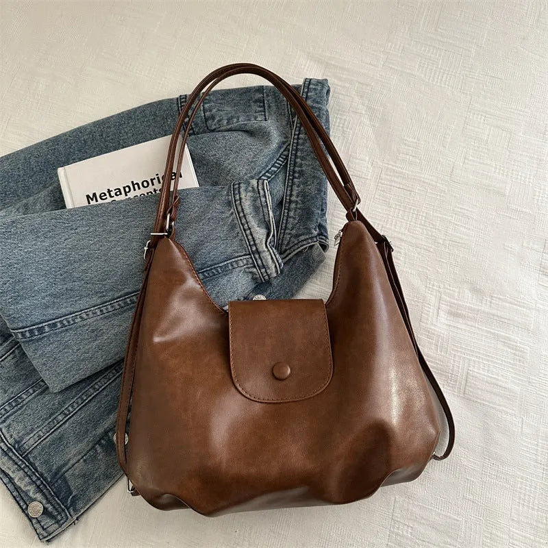 Black leather PU women's single-shoulder backpack with textured finish and horizontal square shape