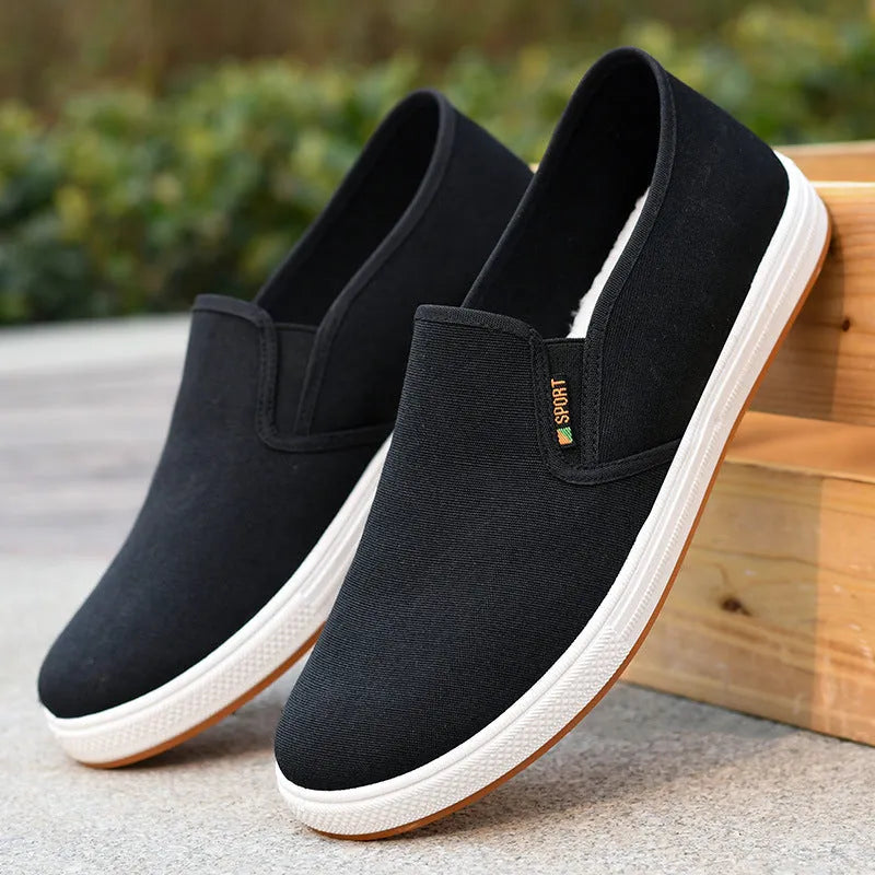 Men's low-top canvas slip-on shoes in blue colour showing round toe and shallow mouth design