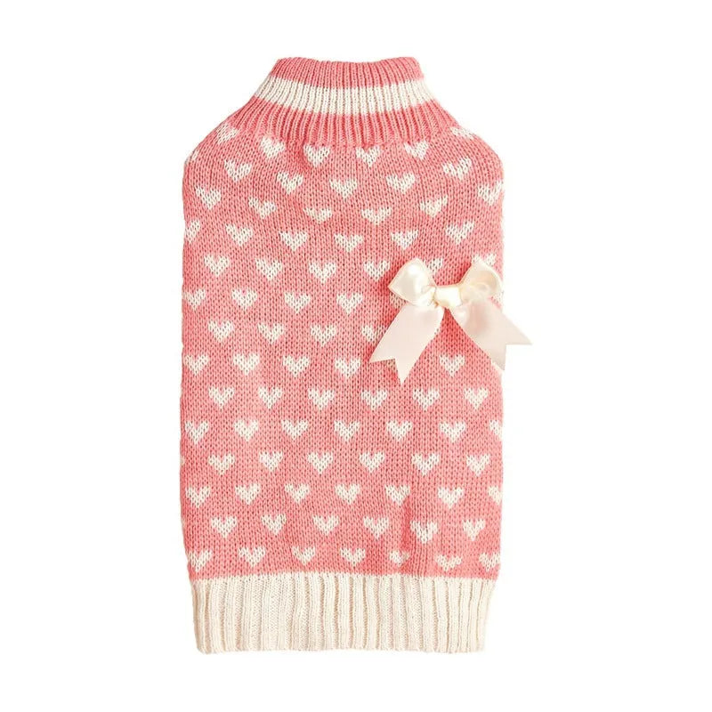 Red dog sweater with a white love heart and bow decoration on a small dog.