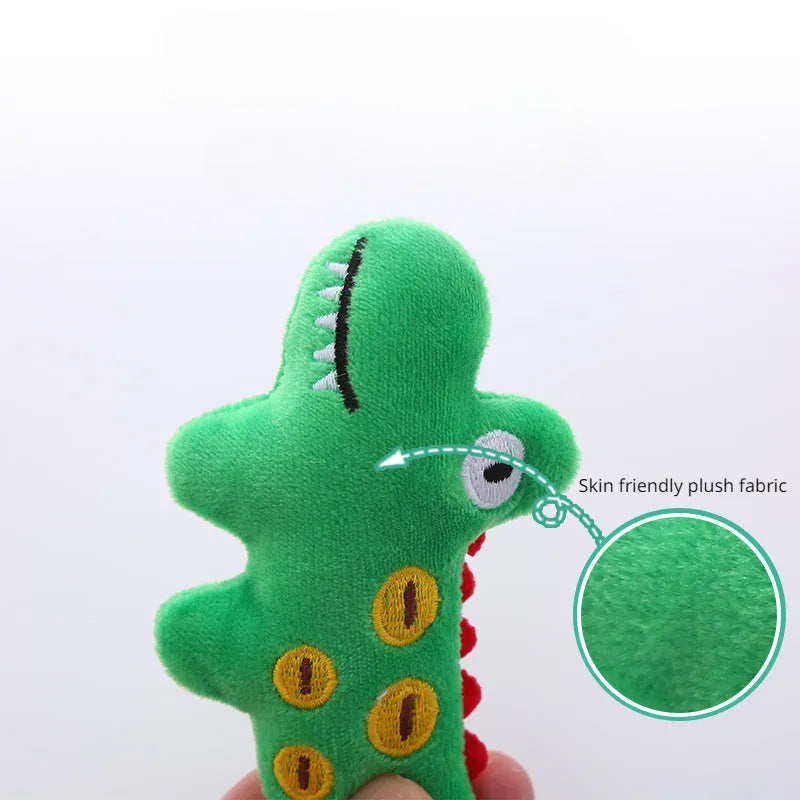 Plush cat toy in shape of a cow, a crocodile, and a parrot on a plain background.