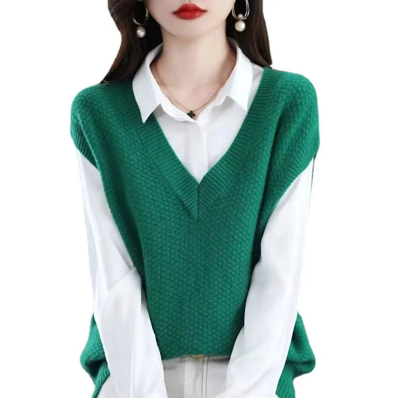 Women's cream V-neck sleeveless knit vest with a raised 3D pattern, laid flat.