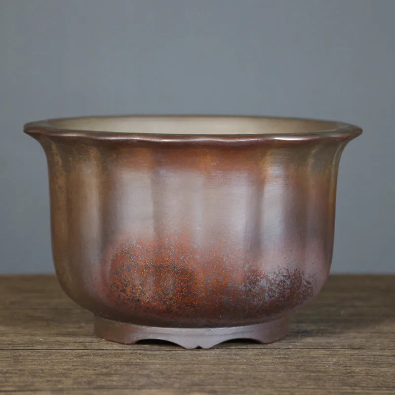 Large antique carved ceramic flower pot in purple sand clay with classical styling for indoor plants
