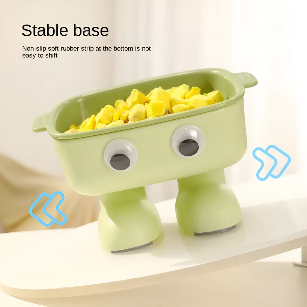 Green cartoon robot shaped elevated cat bowl with tilted food dish on anti-slip base