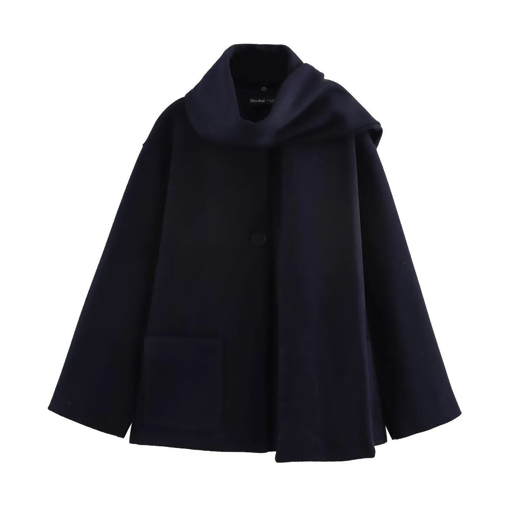 Women's long black polyester overcoat with artificial fur collar and pockets, showing extended length.