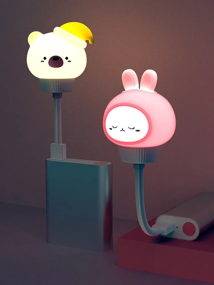 Cartoon animal USB night light in bear shape with remote control on a bedside table