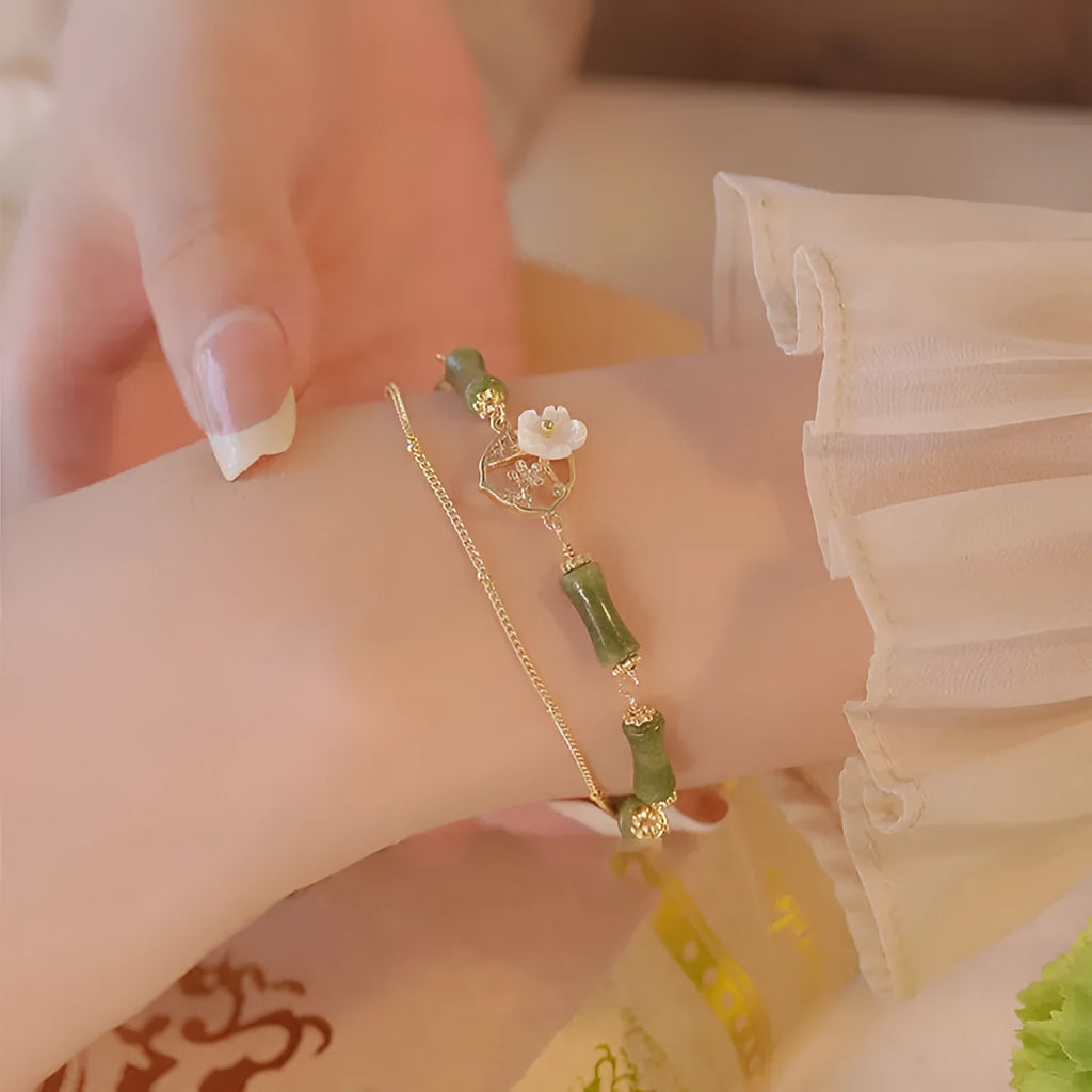 Handmade double layer olivine bracelet with Bells of Ireland charms on a model's wrist