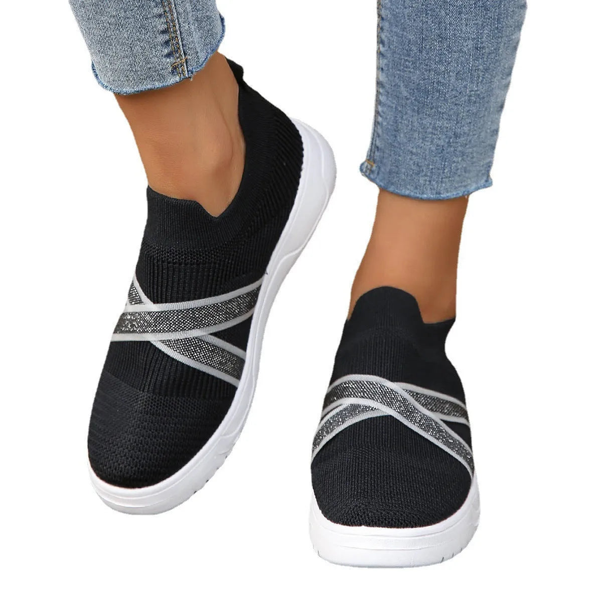 Black women's flyknit mesh casual shoes with flat rubber sole and round toe.
