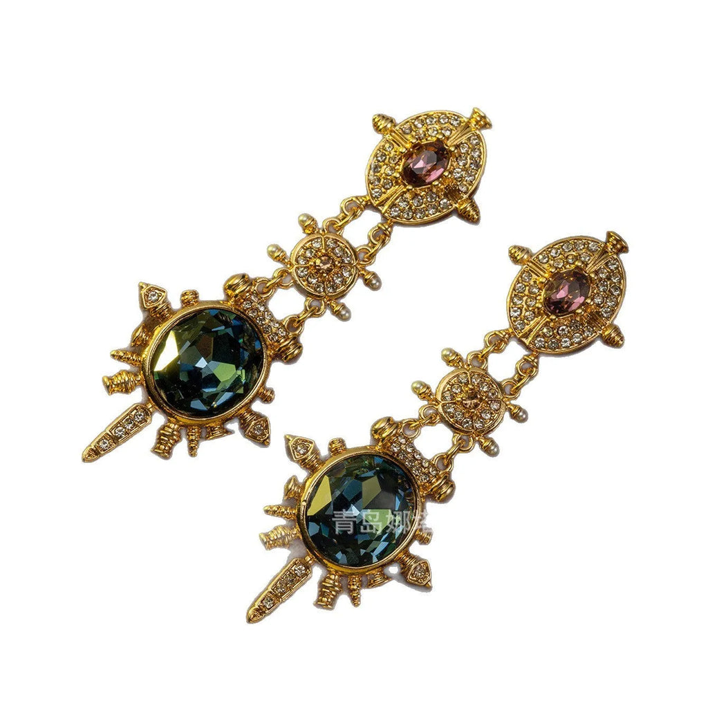 Geometric gold coloured retro stud earrings with round design elements on alloy stud backs