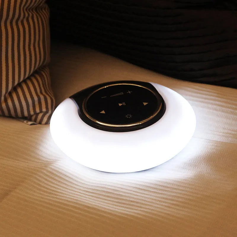 Blue Bluetooth speaker desk lamp with folding design and touch controls showing white, yellow and blue LED lighting