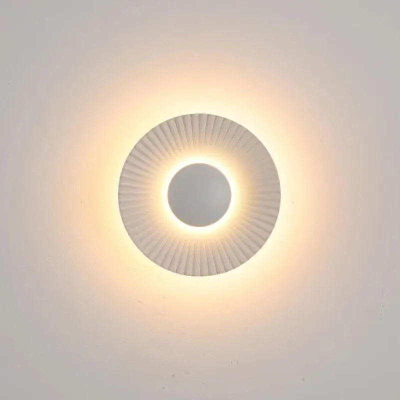Round aluminium wall lamp with white and gold colour options mounted on wall