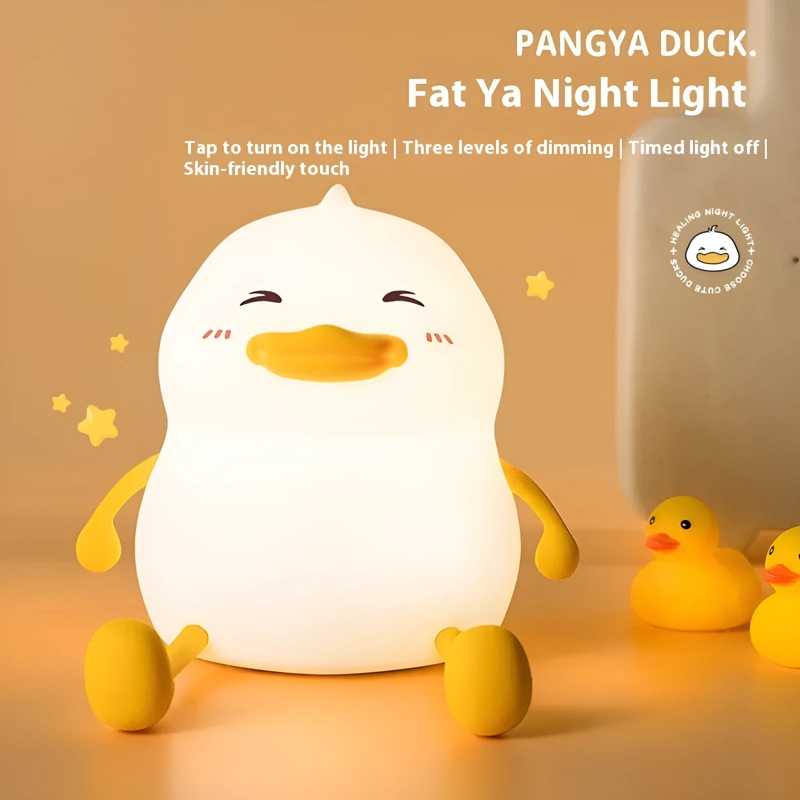 Chubby silicone night light lamp with phone holder on desk, showing soft LED glow and compact 108x104x128mm dimensions