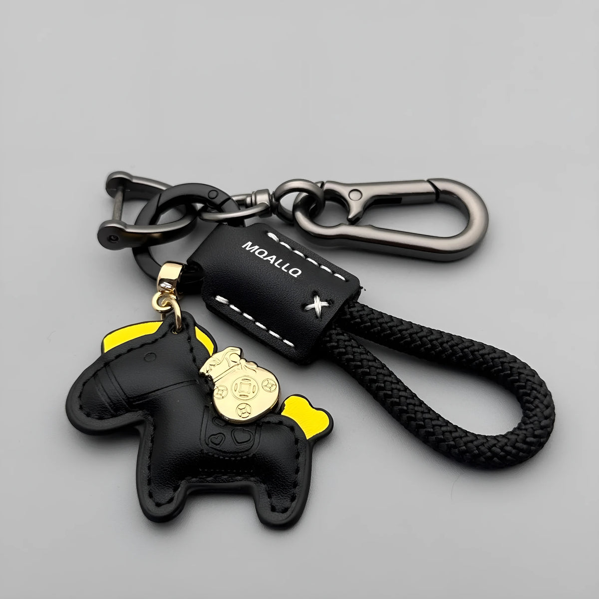 Handmade brown cowhide leather key ring with a gold-toned zinc alloy pony buckle and a green plaited flannelette rope.
