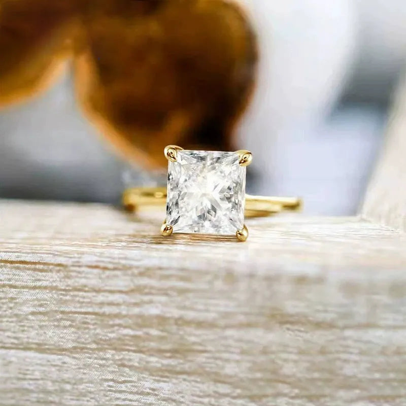 Simple geometric sterling silver ring with round stone on a woman's hand, shown in silver, gold, and rose gold colours.