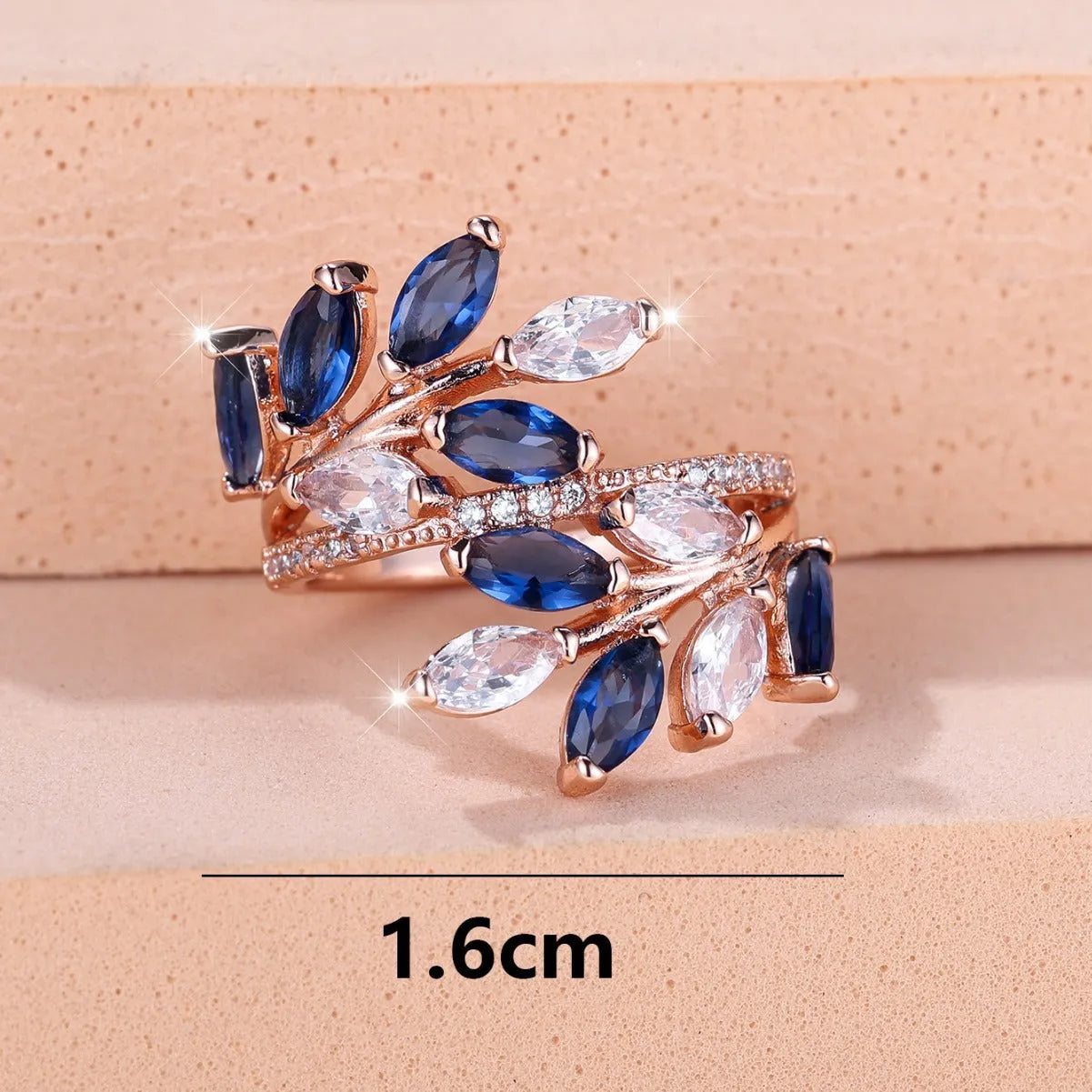 Adjustable copper leaf ring with zircon detailing in multiple colour options on display