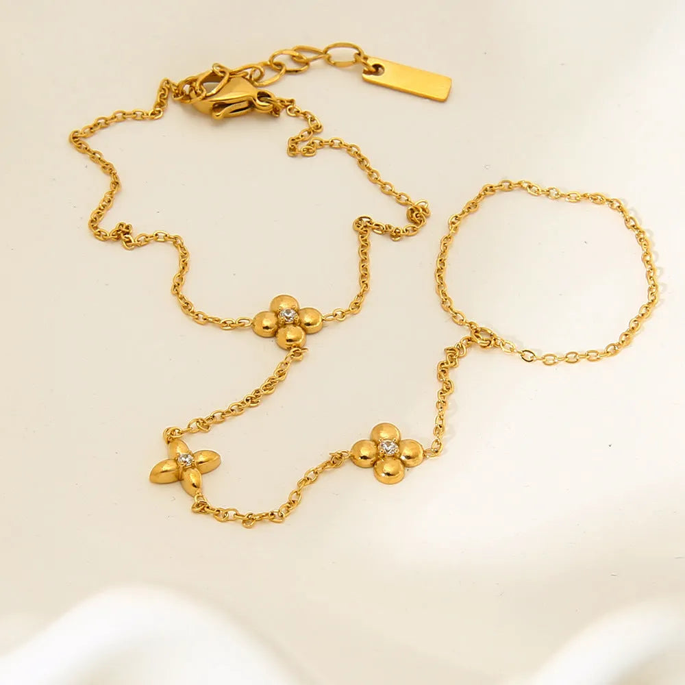 Gold-coloured women's bracelet with floral and eight-pointed star design on stainless steel