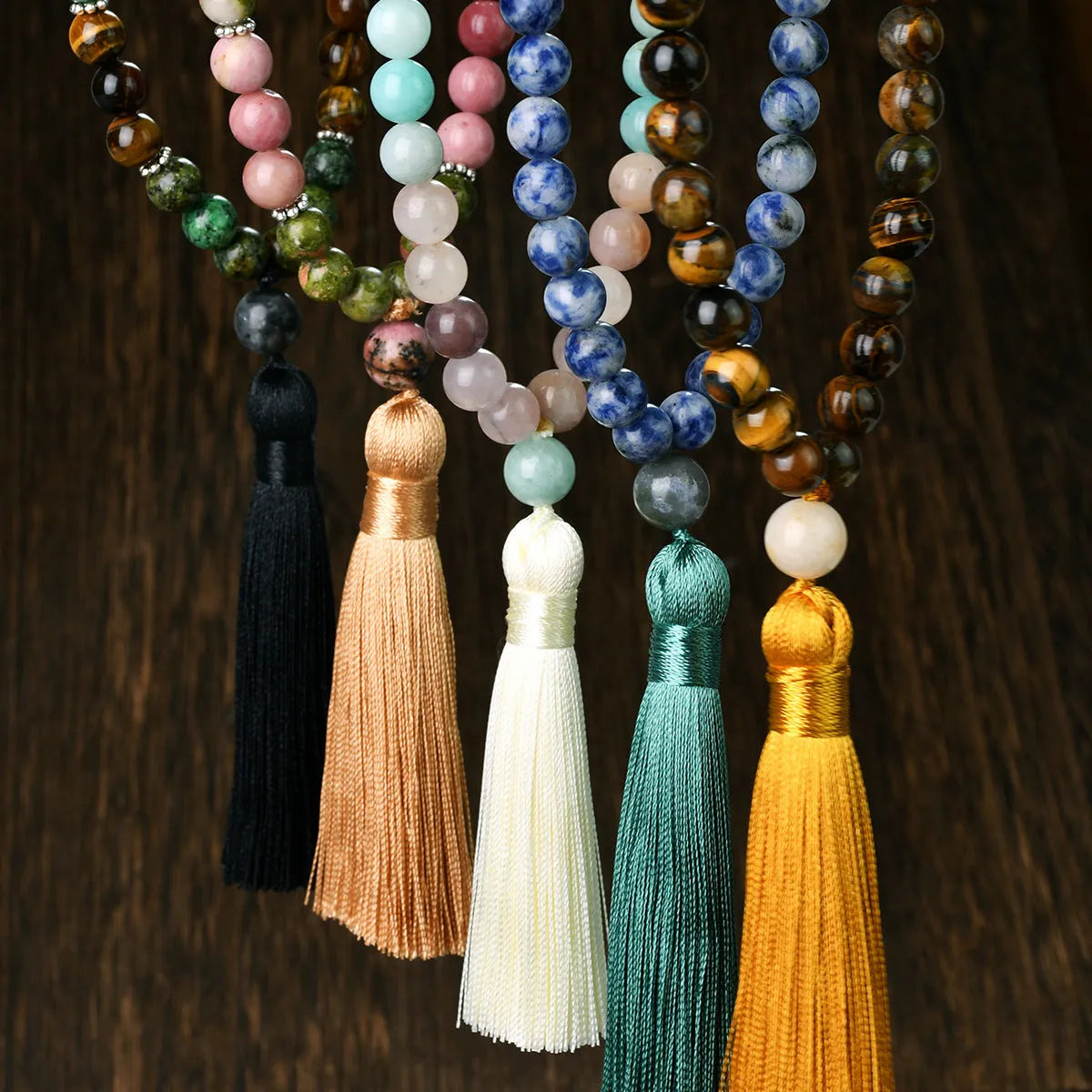 Handmade long beaded necklace with gemstone pendant and tassel, showing 81cm+ length.