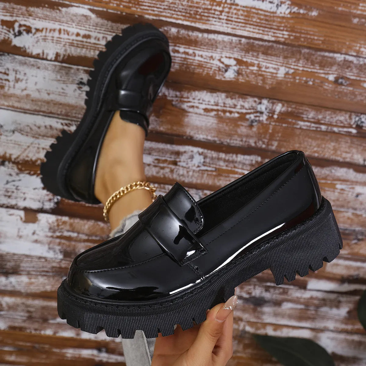 Plus size women's black slip-on loafers with a chunky mid-heel platform and rubber sole