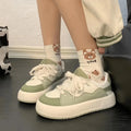 Green women's casual shoes with PU mesh upper and flat heel design on white background