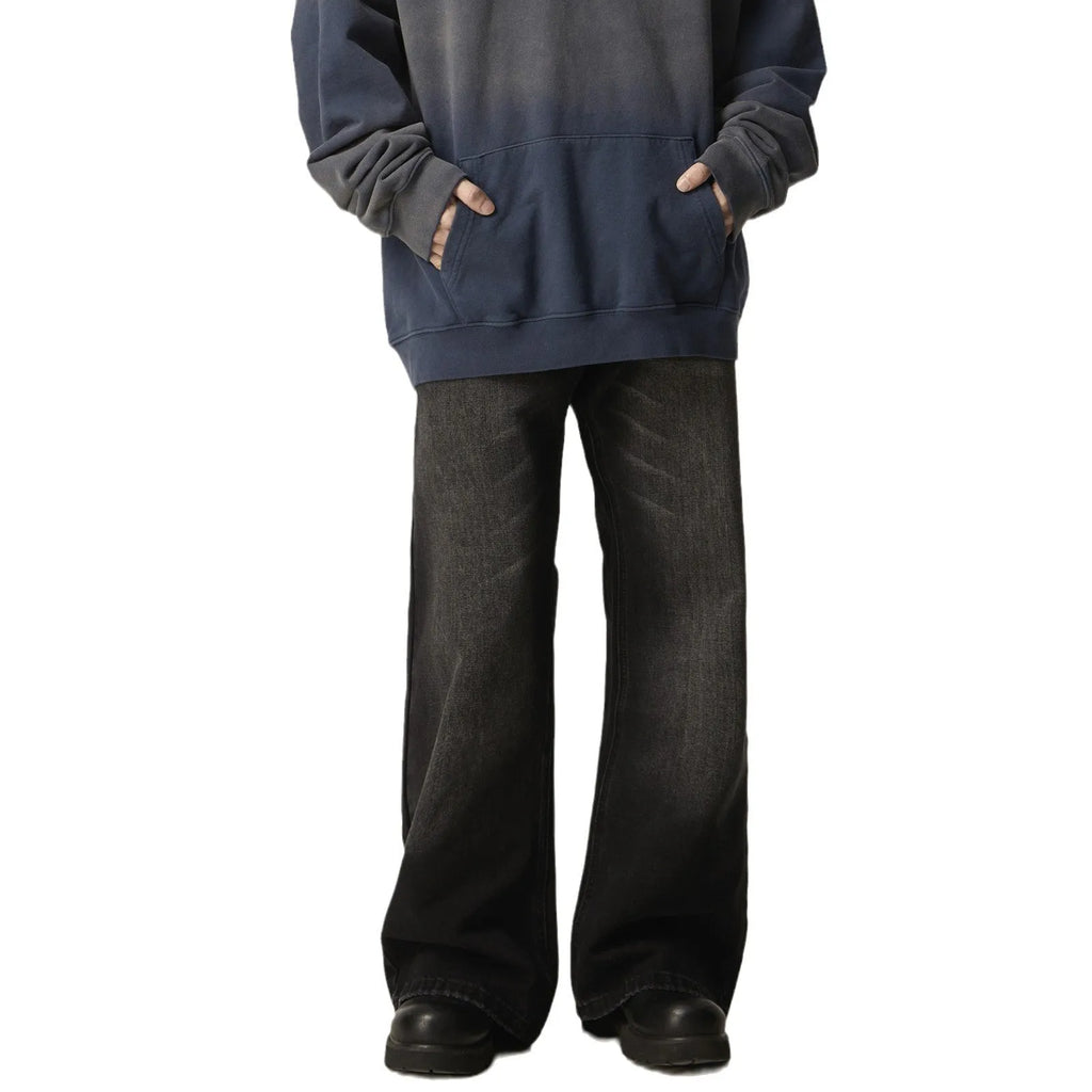 Black loose-fit straight-leg retro jeans with a zipper fly on a mannequin.