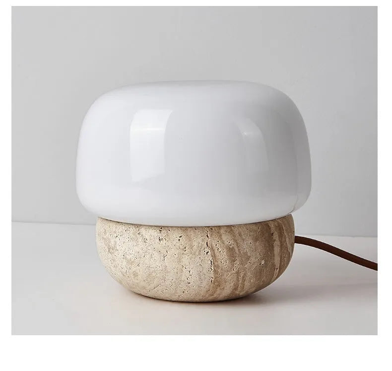 Cream coloured retro ceramic bedside lamp with a globe fabric shade and button switch.