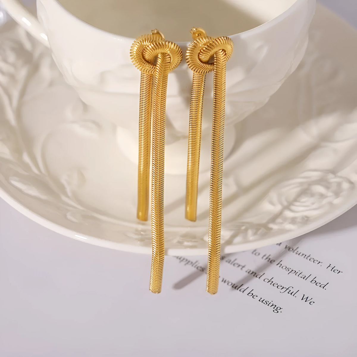 Gold electroplated titanium steel necklace with knotted tassel pendant and matching earrings