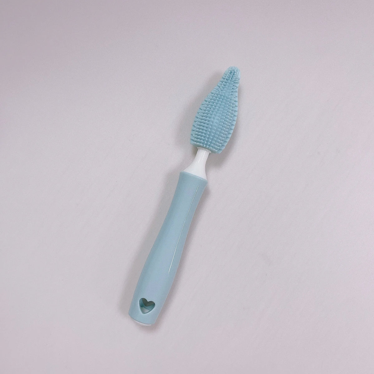 Pink, blue, and yellow silicone baby bottle brush sets with a straw cleaning brush.