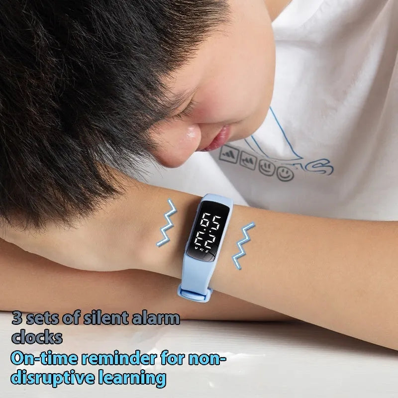 Smart vibration alarm clock watch with coloured silicone strap and LED display on a wrist.
