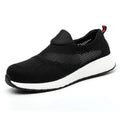 Men's lightweight mesh steel toe work shoe in black, side view on industrial floor.