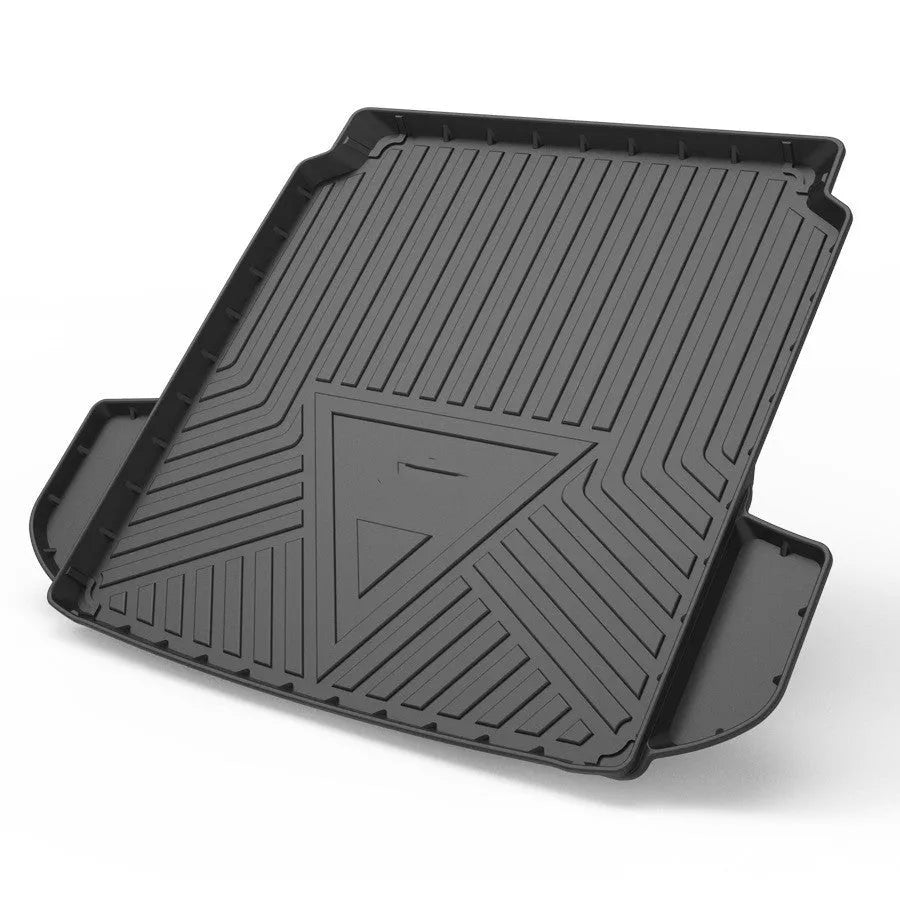 Black TPE car boot liner with carbon fibre pattern texture, shown fitted in a vehicle trunk.