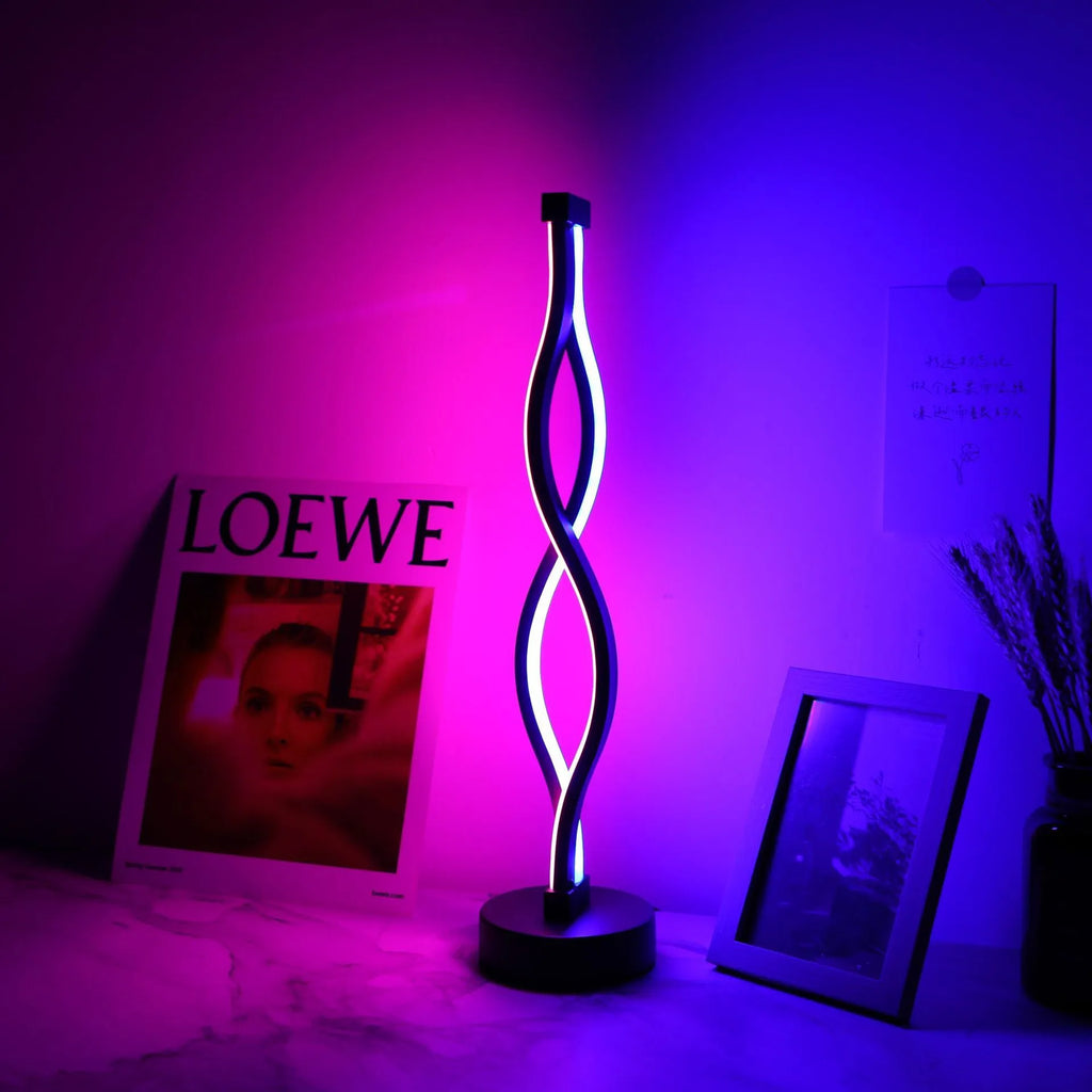 Black aluminium desk lamp with touch dimming and a three-colour button on a desktop