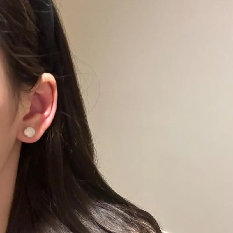 Chinese style chalcedony stud earrings with four-claw stone settings and round geometric design
