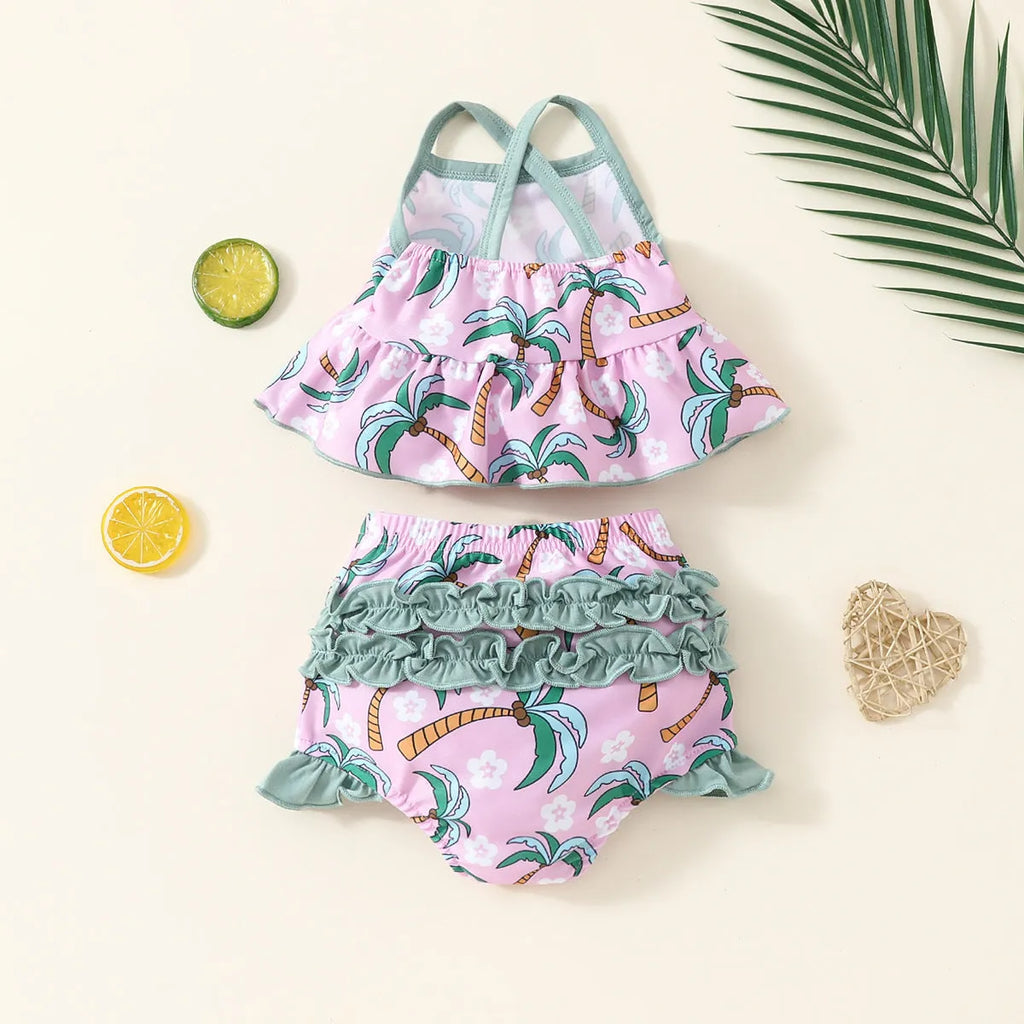 Girls' white two-piece swimsuit set with a shirt top and shorts on a hanger.