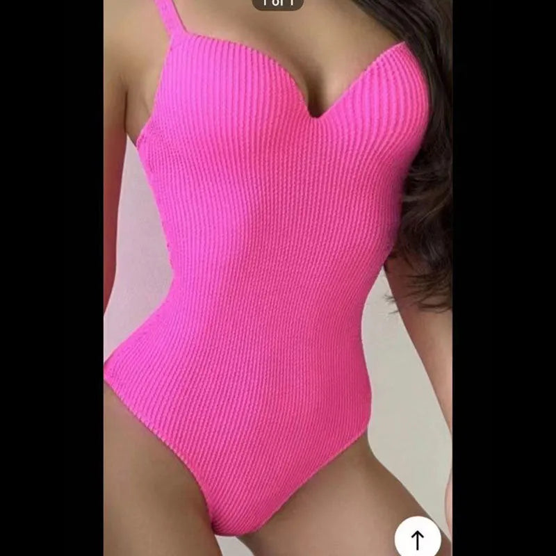 Women's black one-piece swimsuit with a sunken stripe pattern, shown on a mannequin.