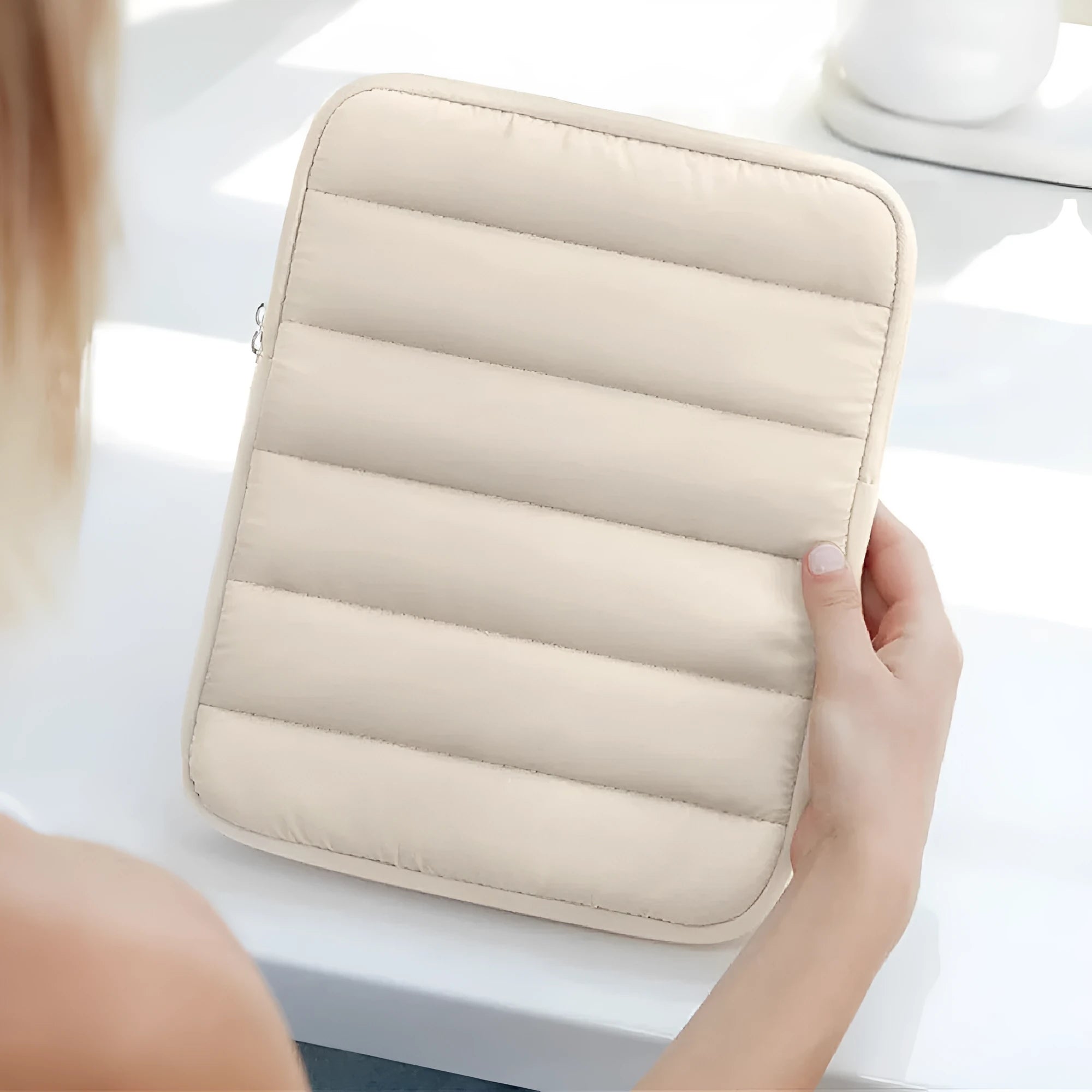 Black puff bag laptop sleeve with fluffy air cushioning for a 9.7 to 11 inch device, shown with elastic sides.