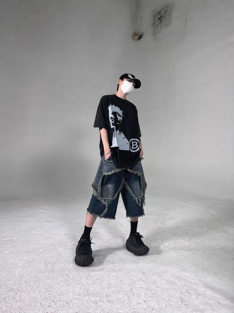Men's blue retro denim shorts with a frayed five-pointed star design on the leg, showing loose fit.