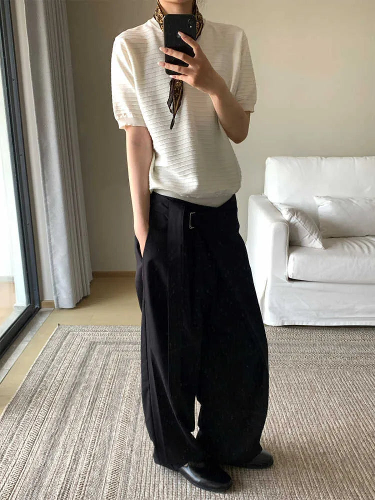 Black straight-leg trousers with a single pleat and adjustable waistband, laid flat.