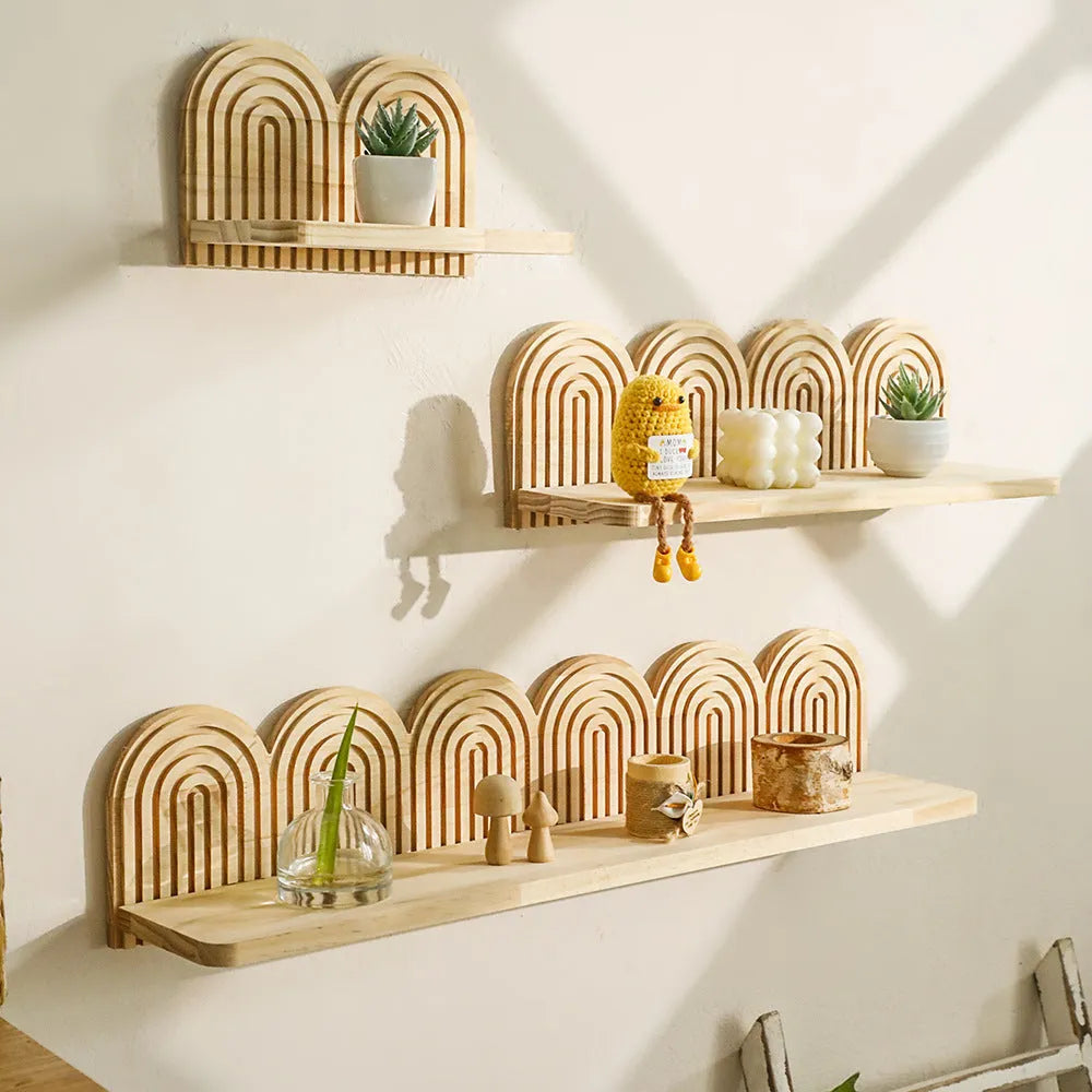 Solid wood multi-layer wall-mounted shelf holding several small potted plants.