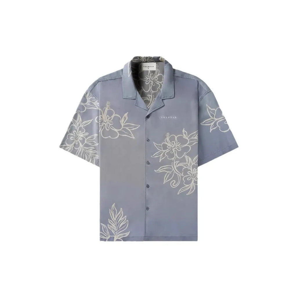Man wearing a loose fit, short sleeve printed floral top in a neutral colour