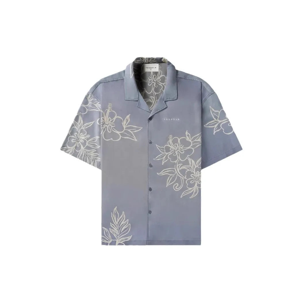 Man wearing a loose fit, short sleeve printed floral top in a neutral colour