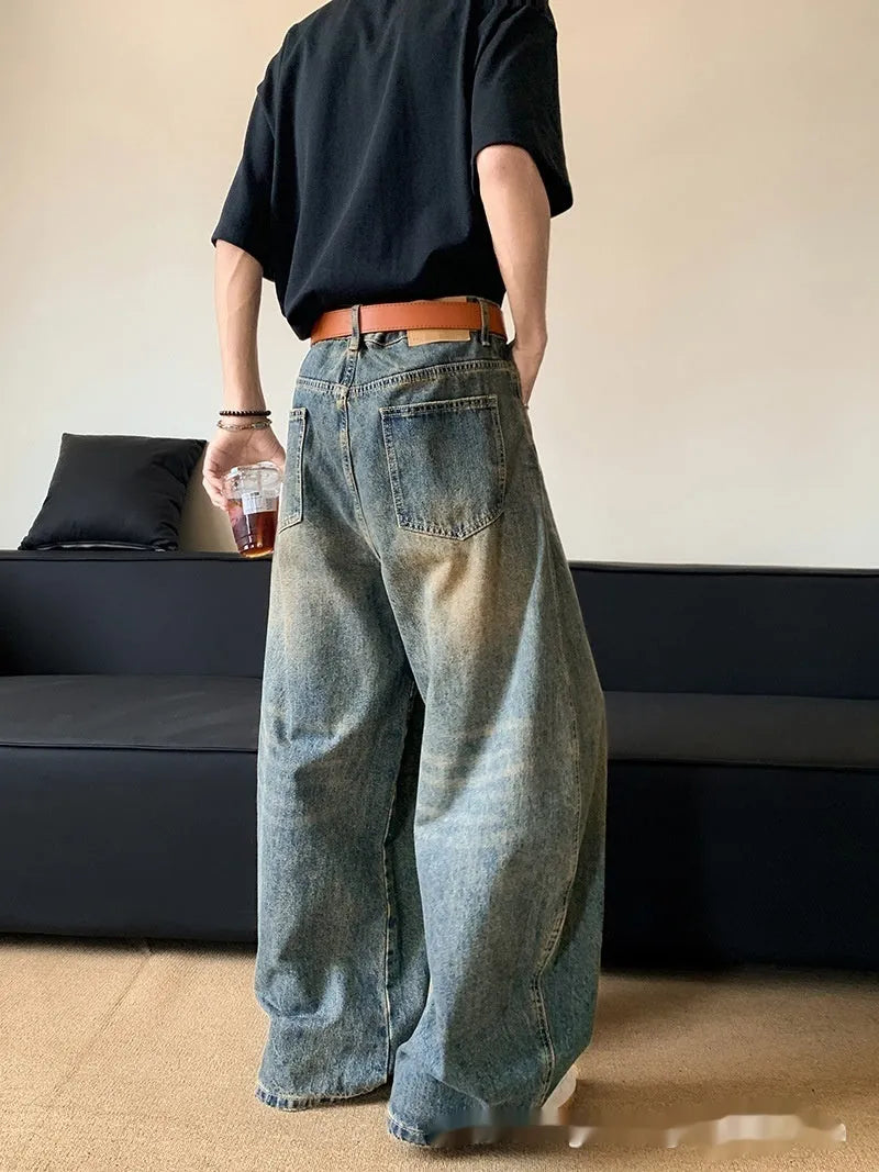 Men's retro blue distressed denim jeans with slim wide-leg cut and micro stretch fabric